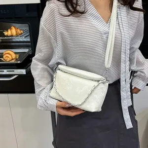 Chic white embossed crossbody bag with silver chain detail for 2025 summer fashion style