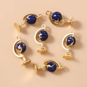 Detail of six blue and gold globe charms for DIY jewelry making and necklace crafts