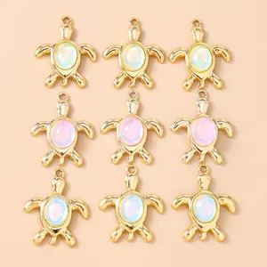 Macro detail of nine alloy turtle pendants with opal stones for DIY jewelry making