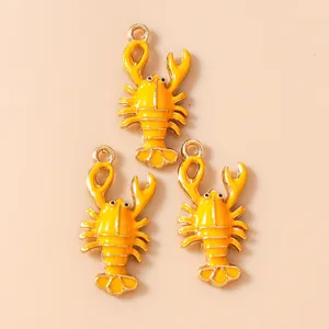 Detailed view of three yellow enamel lobster charms for DIY jewelry making and crafts