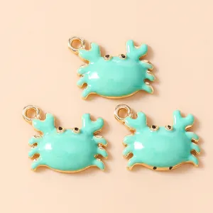 Three mint green crab pendants with gold plating and top loops for DIY jewelry making