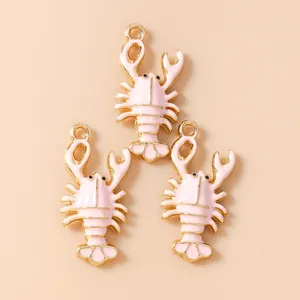 Close-up of pink enamel lobster charms with gold-plated edges for DIY jewelry making