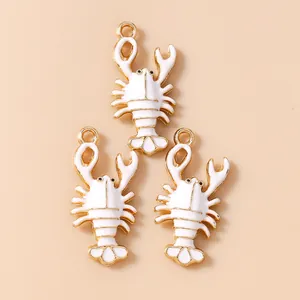 Macro view of gold-plated lobster charms with white enamel inlay for DIY jewelry