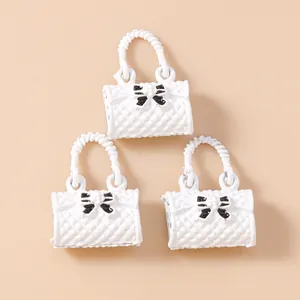 Quilted white mini handbag charms with black bow for DIY jewelry making