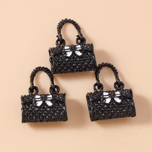 Three mini black quilted handbag pendants with white bows for jewelry and keychain making