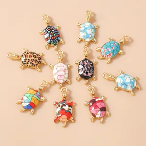 Macro view of 10 assorted sea turtle charms with colorful enamel patterns for DIY jewelry