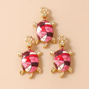 Three gold sea turtle pendants with colorful enamel patterns for DIY jewelry making