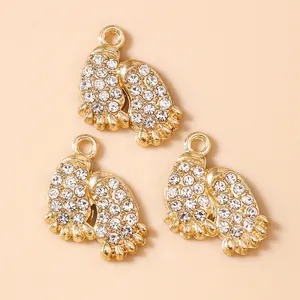 Three gold paw print pendants with white rhinestones for DIY jewelry making
