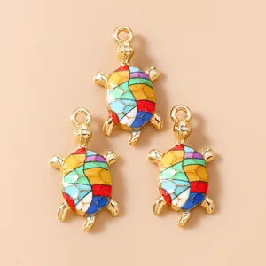 Three gold sea turtle pendants with colorful mosaic enamel for DIY jewelry making