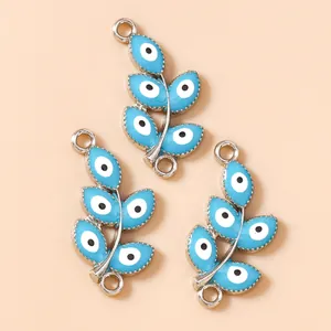 Macro shot of three sky blue evil eye leaf charms with double rings for jewelry making