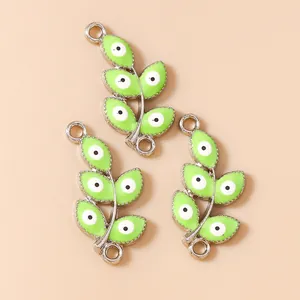 Detailed view of green enamel leaf charms with evil eye design for jewelry DIY