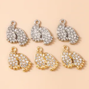 Detail view of crystal-studded baby paw pendants in gold and silver for DIY jewelry