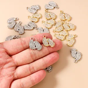 Detailed view of rhinestone-studded paw print pendants in gold and silver finish