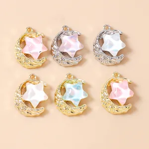 Macro view of alloy moon and star pendants with pearl-like resin inlay for DIY jewelry