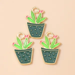 Detailed view of three enamel cactus charms with pink flowers and gold-plated loops