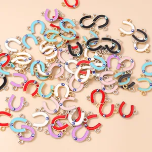 Macro detail of colorful horseshoe evil eye charms with dual loops for DIY jewelry
