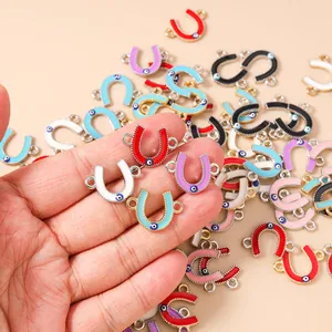 Macro detail of U-shaped horseshoe evil eye charms in assorted colors for DIY jewelry