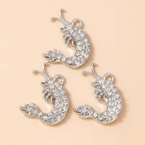 Three silver-toned lobster pendants with clear rhinestones for DIY jewelry making