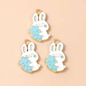 Three white cartoon rabbit alloy pendants holding carrots with gold trim DIY charms