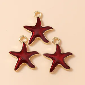 Three starfish pendants with gold frame and deep red enamel for DIY jewelry making
