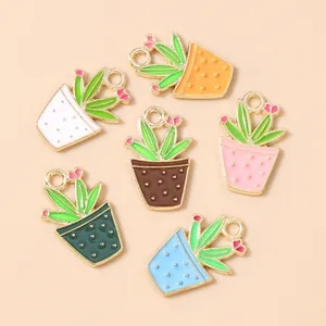 Macro detail of alloy cactus charms with colorful oil-drip flowers for DIY jewelry making