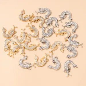 Macro shot of lobster charms in gold and silver plating with white rhinestones for DIY