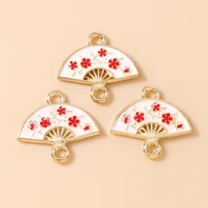 Three gold-plated fan-shaped flower charms with white enamel and pink plum blossom patterns