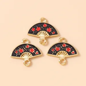 Detail of fan-shaped alloy charms with black enamel and red plum blossom pattern