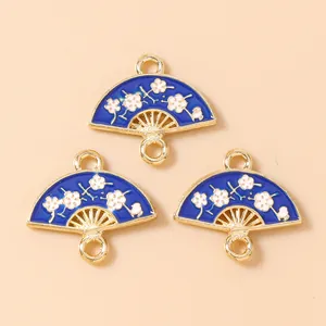 Detailed macro view of three blue enamel flower fan charms for jewelry making