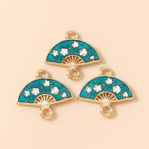 Detail showing blue enamel fan charms with white plum blossoms and gold metal frames