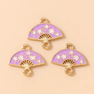 Macro detail of three lavender enamel fan pendants with plum blossom floral pattern