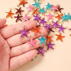 Macro view of colorful starfish charms in hand for DIY jewelry making and crafts