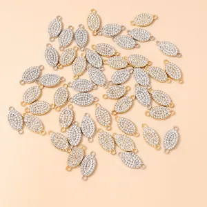 Close-up of sparkling oval rhinestone connectors with dual rings for DIY jewelry making