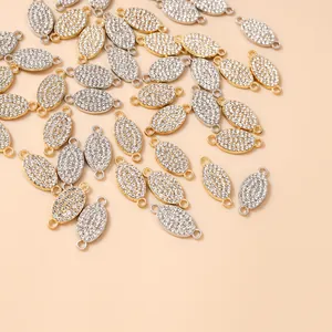 Macro view of gold and silver plated oval jewelry connectors with micro-pave rhinestones