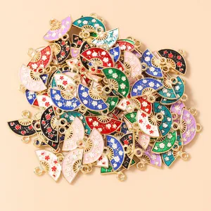 Macro view of colorful enamel flower fan pendants with gold metal edges for DIY jewelry
