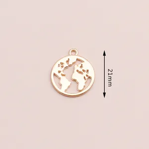 Detail of 21mm gold plated alloy world map pendant for jewelry making on pink background