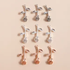 Detailed close-up of rose flower alloy charms in antique silver, bright silver and rose gold