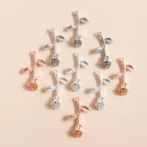 Macro detail of rose flower pendants in silver and rose gold alloy for DIY jewelry making