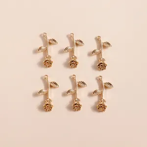 Detailed view of six golden alloy rose flower pendants for DIY jewelry and necklace crafts