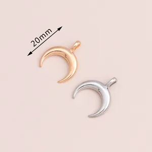 Detail view of 20mm electroplated crescent moon pendants in gold and silver finish