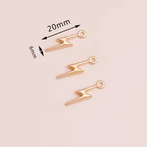 Close-up of three golden lightning bolt charms for DIY jewelry making, 20mm by 6mm size