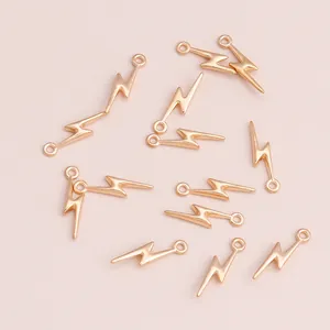 Flat lay of multiple minimalist gold lightning bolt charms for DIY jewelry making