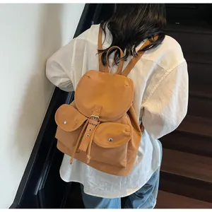 Vue détaillée d'un sac à dos en nylon marron caramel avec deux poches et rabat magnétique