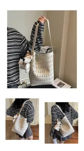 Detail of hollow-out cream white bucket bag with cute plush puppy charm decoration