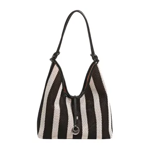 Fashionable black and white striped mesh tote bag with leather strap and metal ring detail