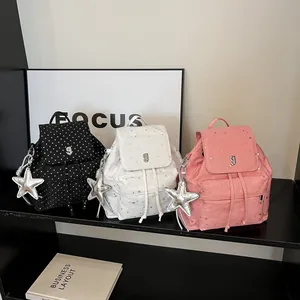 Minimalist polka dot backpack in black white and pink with metallic star charms