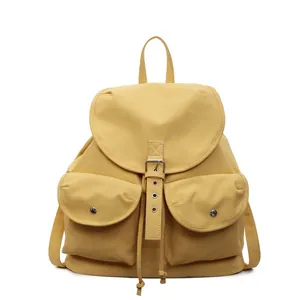 Sac à dos en toile jaune avec boucles métalliques et doubles poches pour le voyage