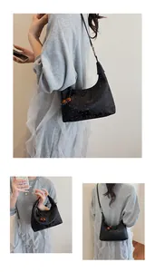 Detailed views of a black polka dot and butterfly print hobo bag with wood bead zipper