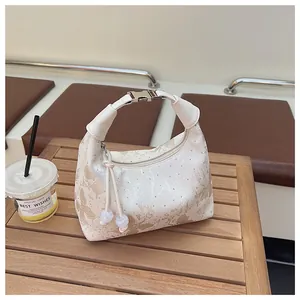 Detail view of cream Hobo bag with marble pattern, featuring silver buckle and beaded strap