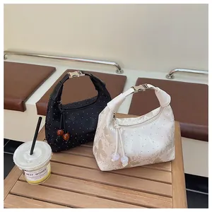 Detail of crescent handbags with marble textures and metallic clasps in a cafe setting